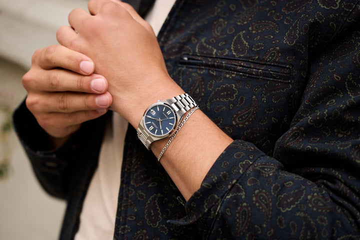 Citizen NJ0200-50M Tsuyosa automatic watch on wrist showing blue dial and integrated bracelet design