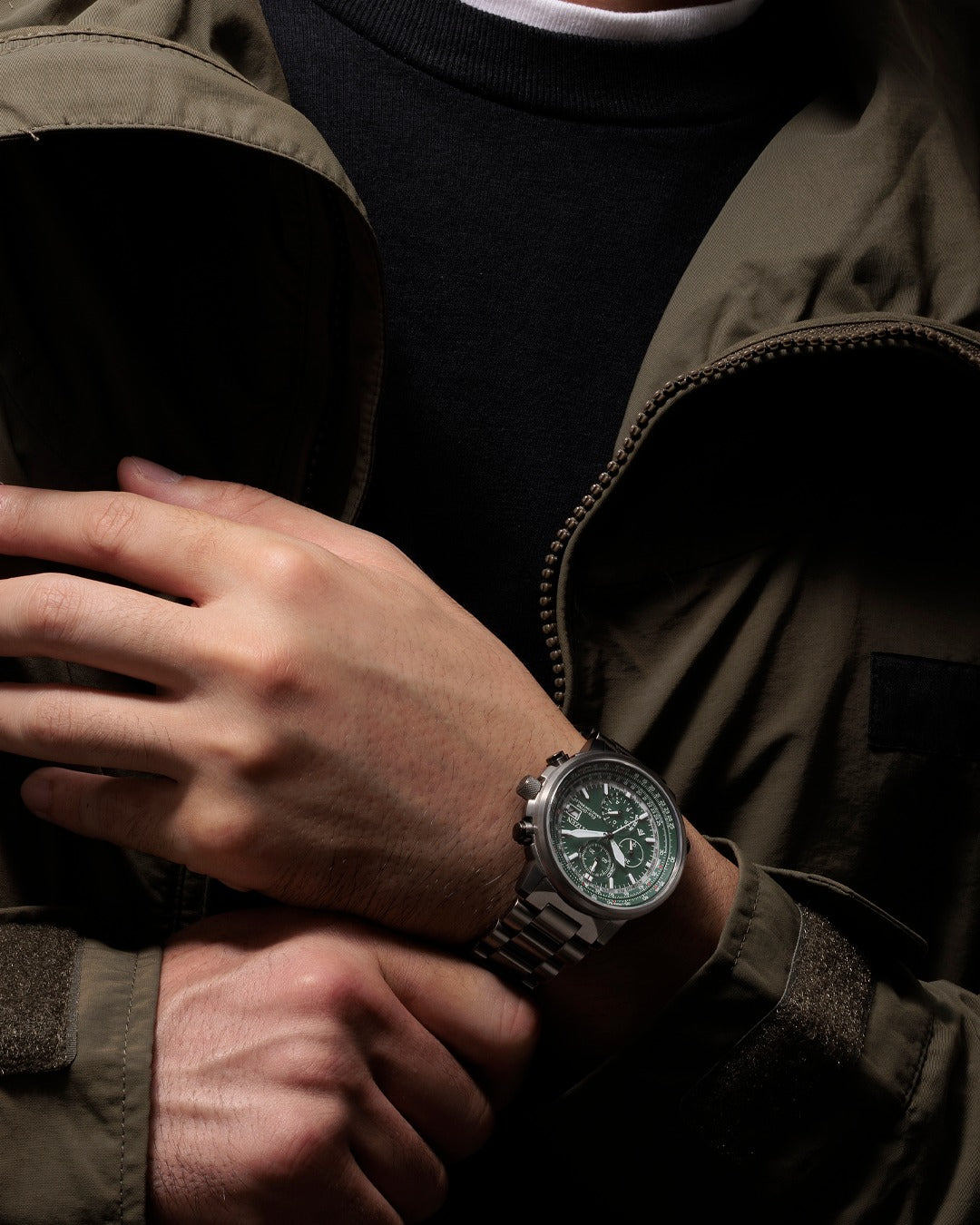 Citizen AT8304-57W Promaster watch on wrist showing stainless steel bracelet and green dial design