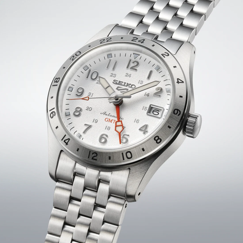 Seiko 5 Sports SSK059K1 Field GMT automatic men's watch — white overwhite dial with orange GMT hand and 24-hour scale bezel, stainless steel case and bracelet, 3/4 angle view
