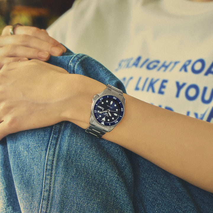 Seiko 5 Sports SRPL77K1 blue dial detail with hand-winding capability and 100m water resistance