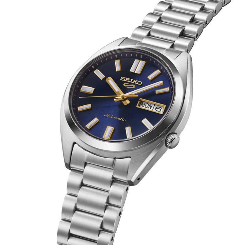 Seiko 5 Sports SRPL55K1 37.4mm stainless steel case side profile — navy blue dial with recessed crown and curved Hardlex crystal