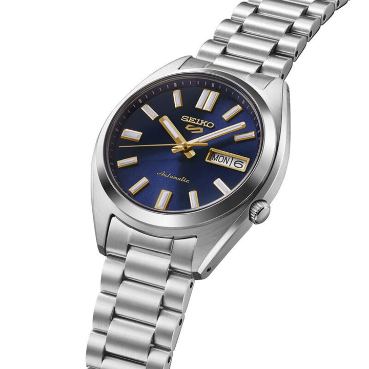 Seiko 5 Sports SRPL55K1 37.4mm stainless steel case side profile — navy blue dial with recessed crown and curved Hardlex crystal