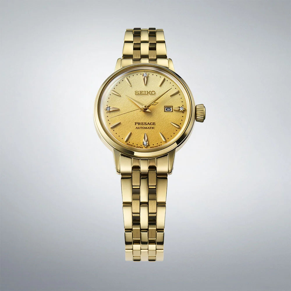 Seiko Presage SRE018J1 close-up showing gold dial with four diamond markers and date display