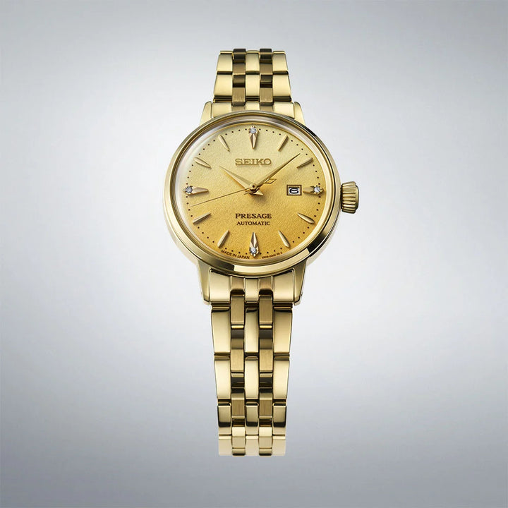 Seiko Presage SRE018J1 close-up showing gold dial with four diamond markers and date display