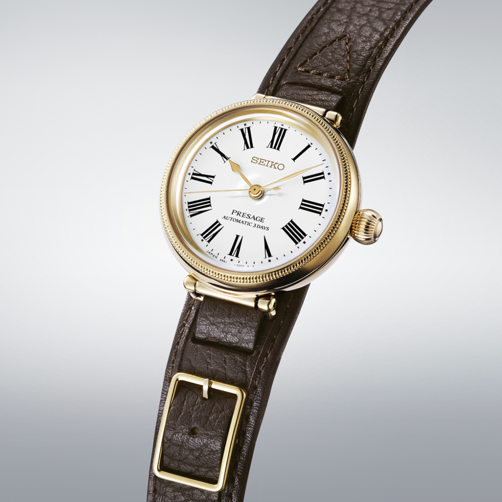 Seiko Presage SPB538J1 35mm automatic watch — white hand-enamelled dial with Roman numerals, gold-coloured millegrain bezel, onion crown, dark brown pull-through leather strap, 3/4 angle view