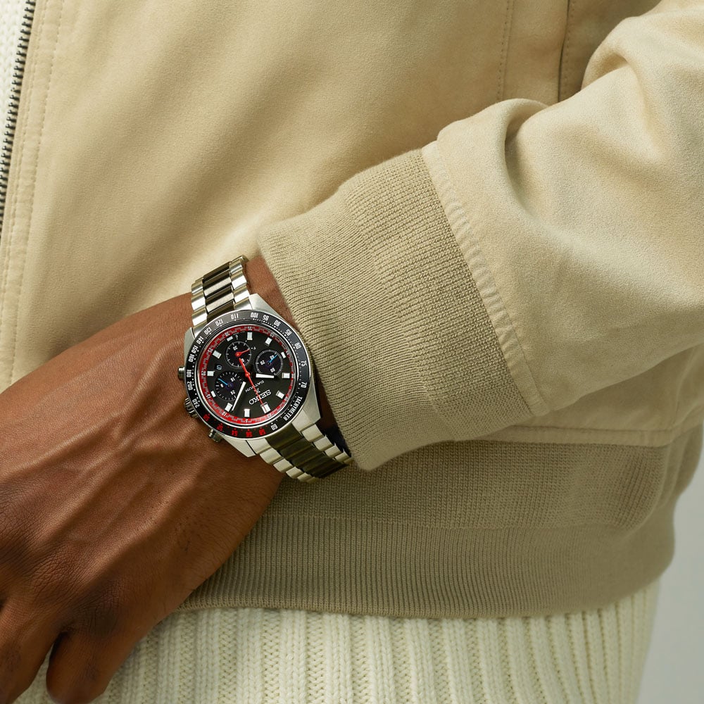 Seiko Prospex Speedtimer SSC957P1 Datsun 240Z limited edition worn on wrist — black dial with red accents and tachymeter bezel, stainless steel bracelet