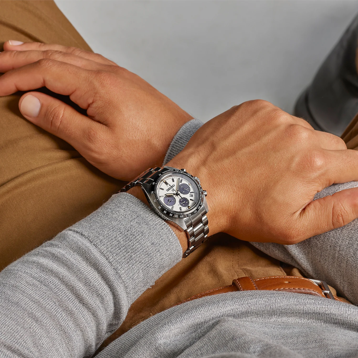 Seiko Prospex Speedtimer SSC961P1 solar chronograph worn on wrist — white panda dial with black tachymetre bezel and stainless steel bracelet, casual lifestyle shot